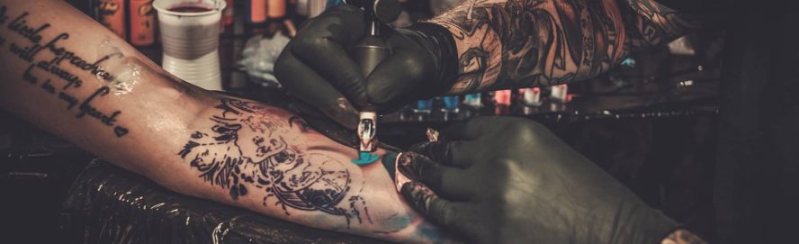 Close-up short of a person getting a tattoo on their arm.