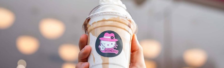 Person holding up a branded Hi Kitty milkshake outside the Liverpool restaurant.